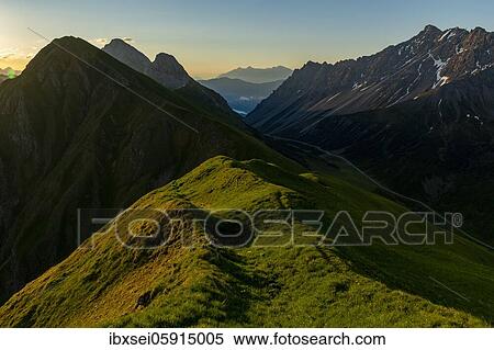 Stock Photography - Mountain meadow of the Habart ridge in the foreground with mountains of the Maldon ridge in the background at sunrise, Elmen, Lechtaler Alps, Außerfern, Tyrol, Austria, Europe. Fotosearch