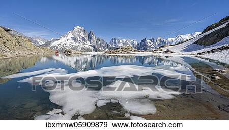 Stock Photo - Mountain panorama, ice floe on Lac Blanc, mountain peaks reflected in mountain lake, Grandes Jorasses and Mont Blanc massif, Chamonix-Mont-Blanc, Haute-Savoie, France, Europe. Fotosearch