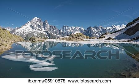 Stock Photo - Mountain panorama, ice floe on Lac Blanc, mountain peaks reflected in mountain lake, Grandes Jorasses and Mont Blanc massif, Chamonix-Mont-Blanc, Haute-Savoie, France, Europe. Fotosearch