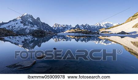 Mountain panorama with water reflection in Lac Blanc, mountain tops, Aiguille Verte, Grandes Jorasses, Aiguille du Moine, Mont Blanc, Mont Blanc massif, Chamonix-Mont-Blanc, Haute-Savoie, France, Europe View Large Photo Image Stock Photo - Mountain panorama with water reflection in Lac Blanc, mountain tops, Aiguille Verte, Grandes Jorasses, Aiguille du Moine, Mont Blanc, Mont Blanc massif, Chamonix-Mont-Blanc, Haute-Savoie, France, Europe. Fotosearch