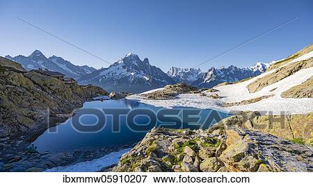 Mountain panorama with water reflection in Lac Blanc, mountain tops, Aiguille Verte, Grandes Jorasses, Aiguille du Moine, Mont Blanc, Mont Blanc massif, Chamonix-Mont-Blanc, Haute-Savoie, France, Europe View Large Photo Image Stock Photo - Mountain panorama with water reflection in Lac Blanc, mountain tops, Aiguille Verte, Grandes Jorasses, Aiguille du Moine, Mont Blanc, Mont Blanc massif, Chamonix-Mont-Blanc, Haute-Savoie, France, Europe. Fotosearch