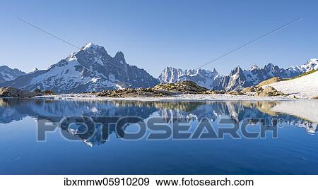Stock Photo - Mountain panorama with water reflection in Lac Blanc, mountain tops, Aiguille Verte, Grandes Jorasses, Aiguille du Moine, Mont Blanc, Mont Blanc massif, Chamonix-Mont-Blanc, Haute-Savoie, France, Europe. Fotosearch