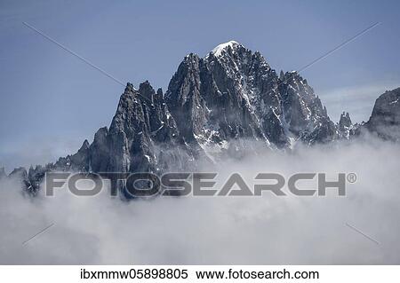 Stock Photography - Mountain peak in clouds, Aiguille Verte, Chamonix, Haute-Savoie, France, Europe. Fotosearch