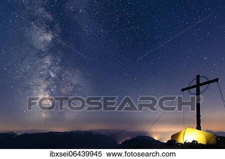 Night sky with stars and milky way over Lechtal mountains, in the foreground summit cross of the Geierkopf with tent, Reutte, Ammergau Alps, Tyrol, Austria, Europe View Large Photo Image Stock Photography - Night sky with stars and milky way over Lechtal mountains, in the foreground summit cross of the Geierkopf with tent, Reutte, Ammergau Alps, Tyrol, Austria, Europe. Fotosearch