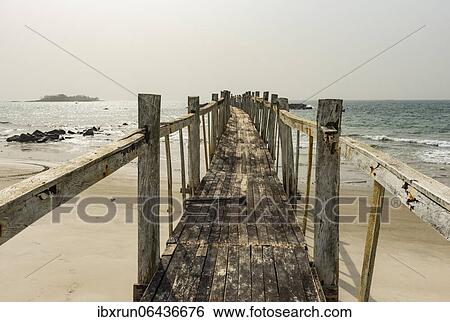 Old wooden pier in the Tokeh Beach, Sierra Leone, Africa View Large Photo Image Stock Photograph - Old wooden pier in the Tokeh Beach, Sierra Leone, Africa. Fotosearch