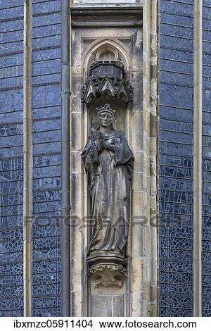 Picture - Praying saint, figure on facade of the gothic Lambertikirche, Münster, North Rhine-Westphalia, Germany, Europe. Fotosearch
