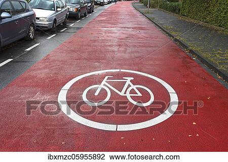 Stock Image - Red marked bicycle road, cars are subordinate, Münster, North Rhine-Westphalia, Germany, Europe. Fotosearch