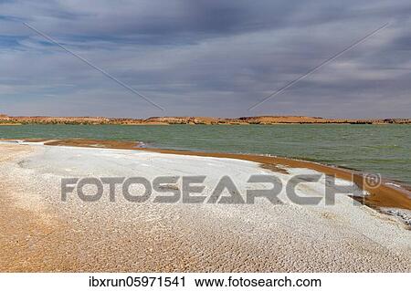 Stock Image - Salt crust at the shores of Ounianga kebir part of the the Unesco sight Ounianga lakes, northern Chad, Africa. Fotosearch