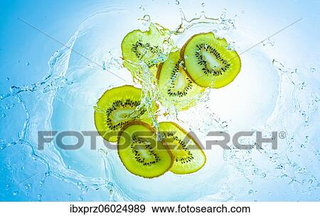 Slices of the kiwi with water splashes, light blue background View Large Photo Image Stock Photo - Slices of the kiwi with water splashes, light blue background. Fotosearch