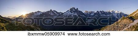 Picture - Sun in front of mountains, Mer de Glace and Glacier d'Argentière, Aiguille Verte, Aiguille du Midi, Aiguille du Moine, Mont Blanc, Grandes Jorasses, Mont Blanc Massif, Chamonix-Mont-Blanc, Haute-Savoie, France, Europe. Fotosearch