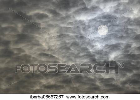 Stock Photo - Sun shines through cloudy sky, North Rhine-Westphalia, Germany, Europe. Fotosearch