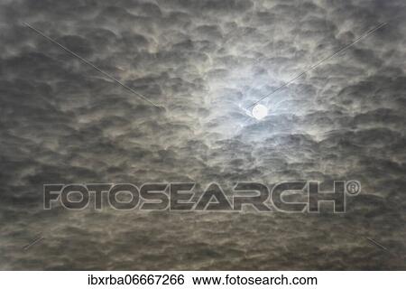 Sun shines through cloudy sky, North Rhine-Westphalia, Germany, Europe View Large Photo Image Stock Photograph - Sun shines through cloudy sky, North Rhine-Westphalia, Germany, Europe. Fotosearch