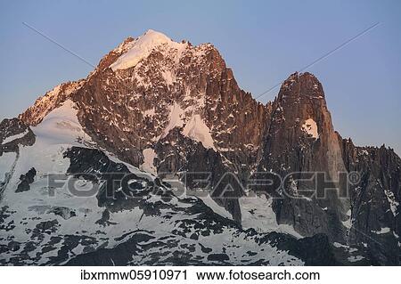 Stock Image - Sunrise, Aiguille Verte with Grand Dru, Mont Blanc Massif, Chamonix-Mont-Blanc, Haute-Savoie, France, Europe. Fotosearch