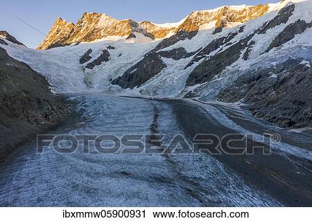 Sunrise, Finsteraarhorn and Agassizhorn, Upper Ice Sea, Mountain panorama, High alpine landscape with mountains and glacier, Bernese Oberland, Switzerland, Europe View Large Photo Image Stock Image - Sunrise, Finsteraarhorn and Agassizhorn, Upper Ice Sea, Mountain panorama, High alpine landscape with mountains and glacier, Bernese Oberland, Switzerland, Europe. Fotosearch