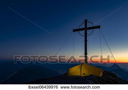 Sunrise over Lechtal mountains, in the foreground summit cross of the Geierkopf with tent, Reutte, Ammergau Alps, Tyrol, Austria, Europe View Large Photo Image Stock Photograph - Sunrise over Lechtal mountains, in the foreground summit cross of the Geierkopf with tent, Reutte, Ammergau Alps, Tyrol, Austria, Europe. Fotosearch