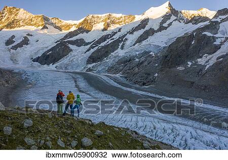 Sunrise, Three (hikers) in front of glacier, Agassizhorn and Großes Fiescherhorn, Upper Ice Sea, Mountain panorama, High alpine landscape with mountains and glacier, Schreckhorn, Bernese Oberland, Switzerland, Europe View Large Photo Image Stock Image - Sunrise, Three (hikers) in front of glacier, Agassizhorn and Großes Fiescherhorn, Upper Ice Sea, Mountain panorama, High alpine landscape with mountains and glacier, Schreckhorn, Bernese Oberland, Switzerland, Europe. Fotosearch