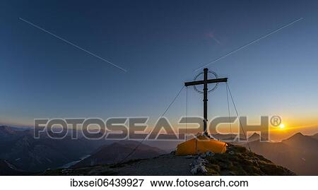 Sunset over Lechtal mountains, in the foreground summit cross of the Geierkopf with tent, Reutte, Ammergau Alps, Tyrol, Austria, Europe View Large Photo Image Stock Photo - Sunset over Lechtal mountains, in the foreground summit cross of the Geierkopf with tent, Reutte, Ammergau Alps, Tyrol, Austria, Europe. Fotosearch