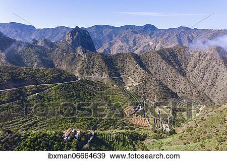 Tamargada settlement and Roque Cano mountain, near Vallehermosos, drone image, La Gomera, Canary Islands, Spain, Europe View Large Photo Image Stock Photo - Tamargada settlement and Roque Cano mountain, near Vallehermosos, drone image, La Gomera, Canary Islands, Spain, Europe. Fotosearch
