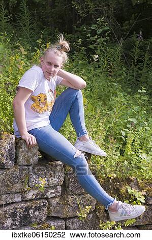 Teenager, young woman sitting on the wall, Baden-Württemberg, Germany, Europe View Large Photo Image Stock Image - Teenager, young woman sitting on the wall, Baden-Württemberg, Germany, Europe. Fotosearch