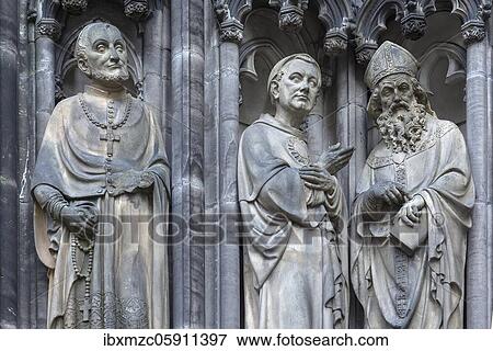 Three figures of saints in detail at the entrance portal of the Lambert Church, Münster, North Rhine-Westphalia, Germany, Europe View Large Photo Image Stock Photo - Three figures of saints in detail at the entrance portal of the Lambert Church, Münster, North Rhine-Westphalia, Germany, Europe. Fotosearch