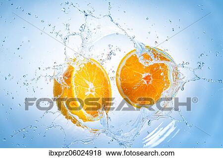 Two halves of oranges fall into water with splashes of water, light blue background View Large Photo Image Stock Photo - Two halves of oranges fall into water with splashes of water, light blue background. Fotosearch