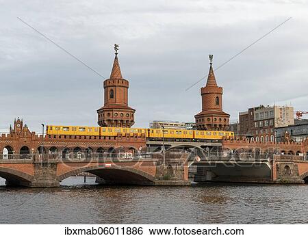 Stock Photograph - Yellow S-Bahn on the Oberbaum Bridge between Kreuzberg and Friedrichshain, Spree, Berlin, Germany, Europe. Fotosearch