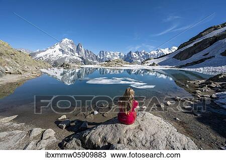 Young woman in front of mountain panorama, reflection in Lac Blanc, mountain peaks, Grandes Jorasses and Mont Blanc massif, Chamonix-Mont-Blanc, Haute-Savoie, France, Europe View Large Photo Image Stock Image - Young woman in front of mountain panorama, reflection in Lac Blanc, mountain peaks, Grandes Jorasses and Mont Blanc massif, Chamonix-Mont-Blanc, Haute-Savoie, France, Europe. Fotosearch