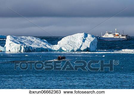 Zodiac cruising back to a cruise ship anchoring behind an iceberg, Brown Bluff, Antarctica View Large Photo Image Stock Image - Zodiac cruising back to a cruise ship anchoring behind an iceberg, Brown Bluff, Antarctica. Fotosearch