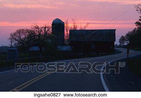 Stock Photo - Barn and silo at sunset. Fotosearch
