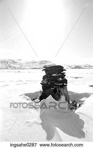 Black and white view of a snow covered cairn View Large Photo Image Stock Photo - Black and white view of a snow covered cairn . Fotosearch