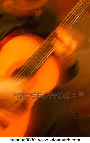 Blur of person playing acoustic guitar View Large Photo Image Stock Image - Blur of person playing acoustic guitar. Fotosearch