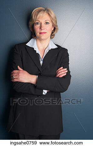 Stock Photo - Business woman leaning against wall. Fotosearch