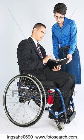 Businessman in wheelchair setting up meeting View Large Photo Image Stock Image - Businessman in wheelchair setting up meeting. Fotosearch