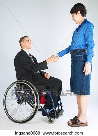 Businessman in wheelchair shaking woman's hand View Large Photo Image Stock Photo - Businessman in wheelchair shaking woman's hand. Fotosearch