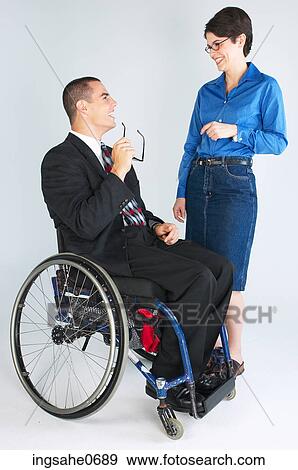 Businessman in wheelchair talking to woman View Large Photo Image Stock Photo - Businessman in wheelchair talking to woman. Fotosearch