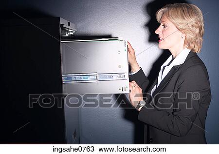 Businesswoman opening safe View Large Photo Image Stock Image - Businesswoman opening safe. Fotosearch