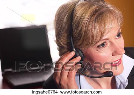 Businesswoman speaking into headset View Large Photo Image Picture - Businesswoman speaking into headset. Fotosearch