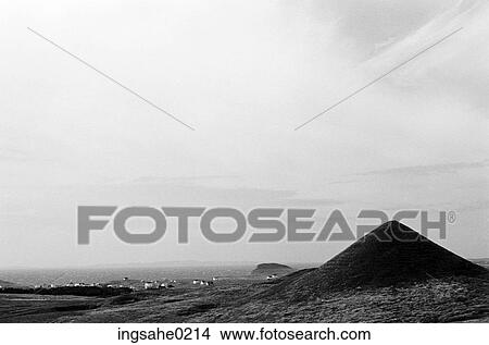 Conical hill with town and ocean in background View Large Photo Image Picture - Conical hill with town and ocean in background . Fotosearch