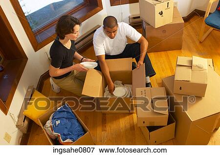 Couple packing dishes in empty apartment 2 View Large Photo Image Stock Photo - Couple packing dishes in empty apartment 2. Fotosearch