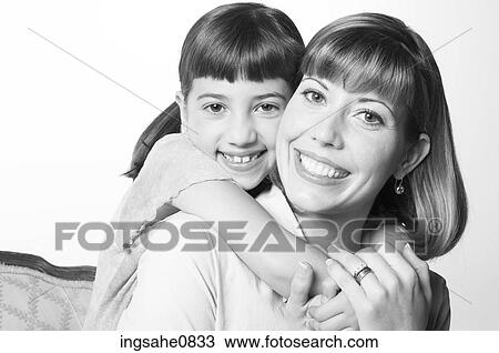 Stock Image - Embracing mother and daughter. Fotosearch