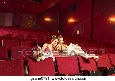 Stock Image - Giggling ballerinas sitting in empty theater 2. Fotosearch