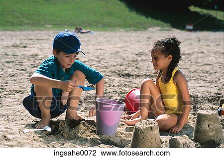 girl and boy playing in sand 0003 View Large Photo Image Stock Image - girl and boy playing in sand 0003. Fotosearch