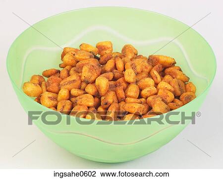 Stock Image - Glass bowl of corn nuts. Fotosearch