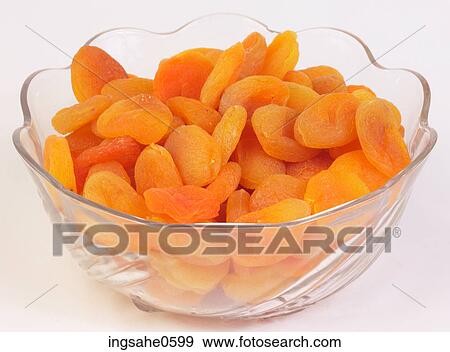 Stock Photo - Glass bowl of dried apricots. Fotosearch