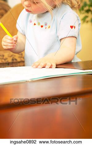 Stock Image - Little girl drawing a picture. Fotosearch