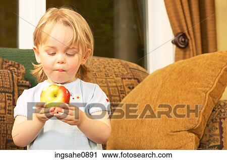 Little girl eating apple View Large Photo Image Stock Image - Little girl eating apple. Fotosearch