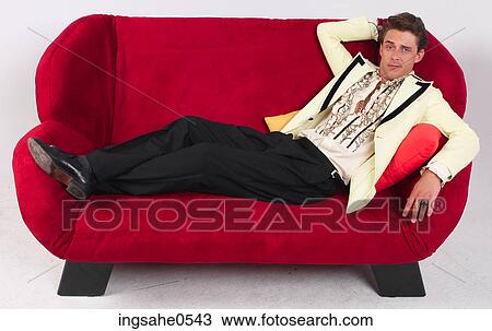 Man in tuxedo relaxing on sofa View Large Photo Image Stock Image - Man in tuxedo relaxing on sofa. Fotosearch