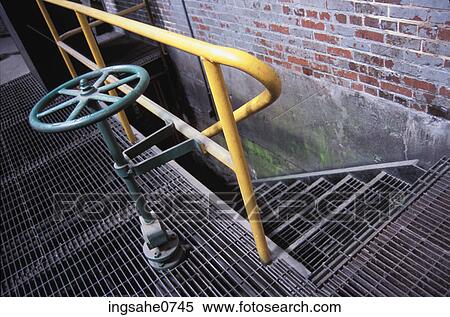 Metal valve and staircase inside old brick factory View Large Photo Image Stock Photography - Metal valve and staircase inside old brick factory. Fotosearch