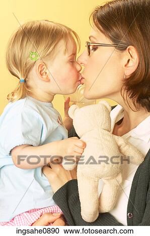 Mother kissing little girl View Large Photo Image Stock Image - Mother kissing little girl. Fotosearch