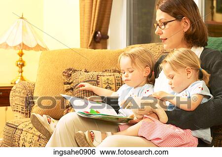 Mother reading story with twin little girls 3 View Large Photo Image Stock Photograph - Mother reading story with twin little girls 3. Fotosearch